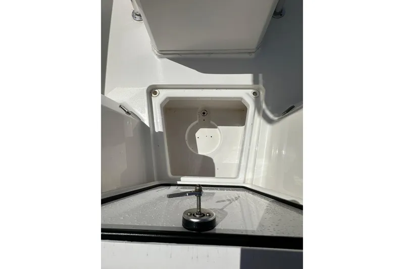 Slide: The Image of 2023 LFG 22CC boat compartment with open hatch and latch detail. - 17