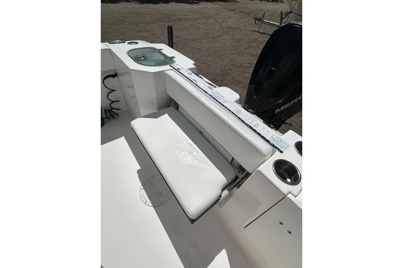 Slide: The Image of 2023 LFG 22CC boat interior with cushioned seating and engine view. - 23