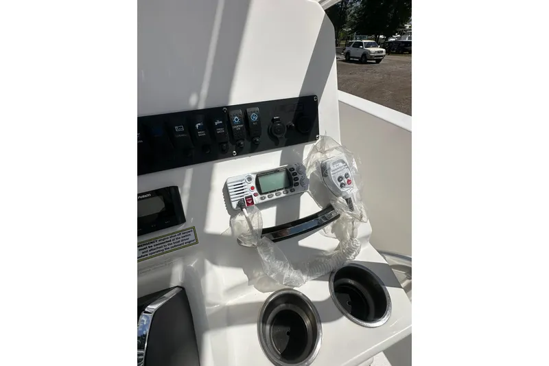 Slide: The Image of Control panel of 2023 LFG 22CC boat with switches and radio equipment. - 27