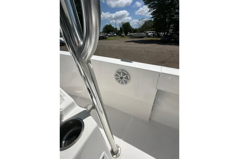 Slide: The Image of 2023 LFG 22CC boat interior with stainless steel railing and speaker, under a clear sky. - 28