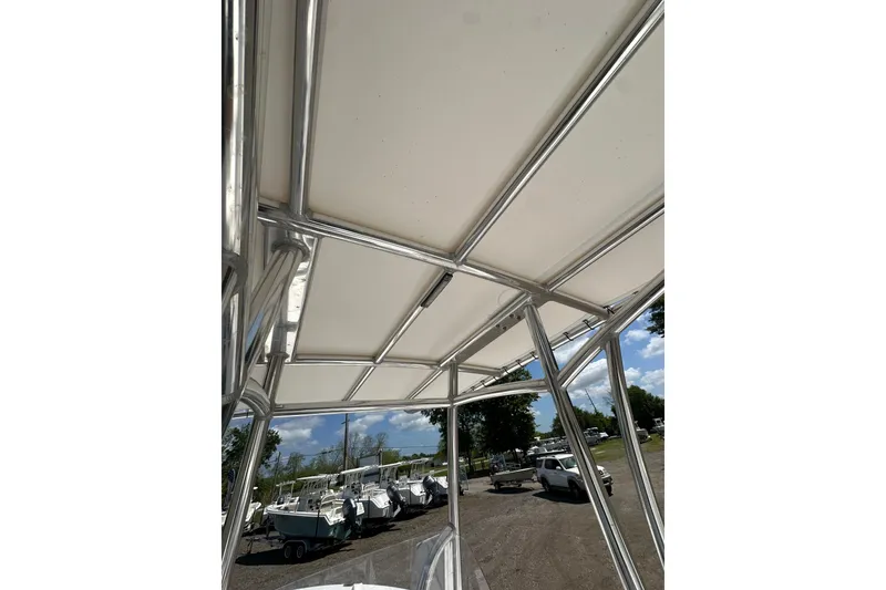Slide: The Image of Aluminum frame and canopy of 2023 LFG 22CC boat, with parked boats in background. - 29