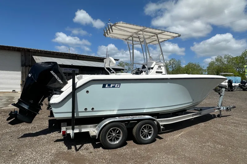 Slide: The Image of 2023 LFG 22CC boat on trailer with Mercury outboard motor, parked outdoors. - 3