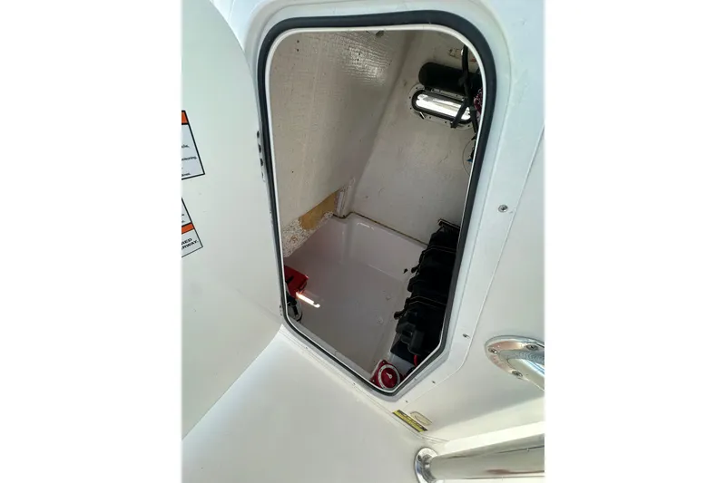 Slide: The Image of Interior view of 2023 LFG 22CC boat compartment with visible wiring and equipment. - 30