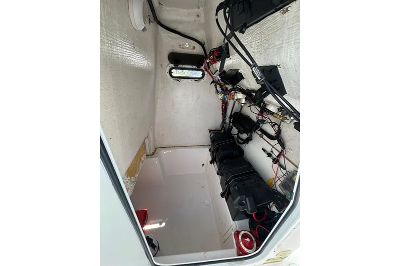 Slide: The Image of Interior view of 2023 LFG 22CC boat showing wiring and battery compartments. - 31