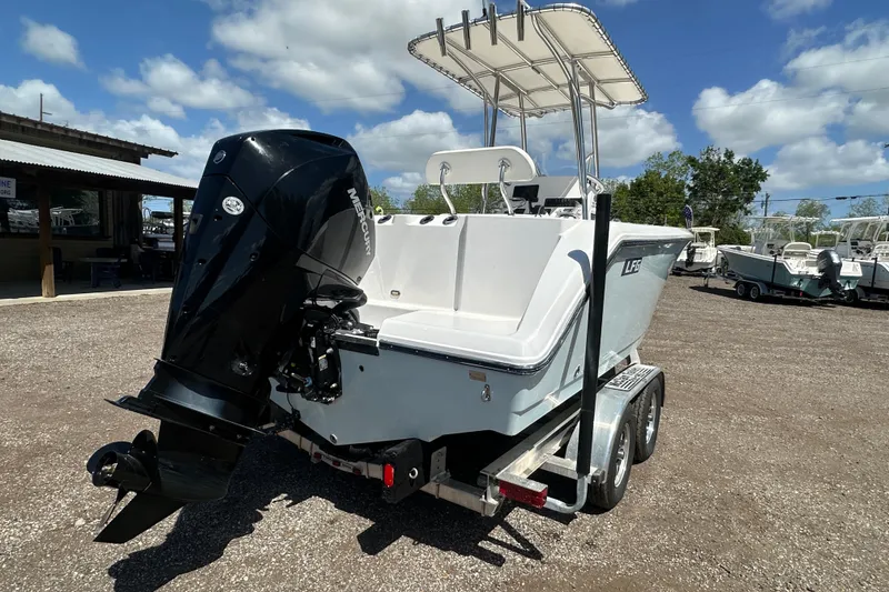 Slide: The Image of 2023 LFG 22CC boat with Mercury outboard motor on a trailer, under a sunny sky. - 4