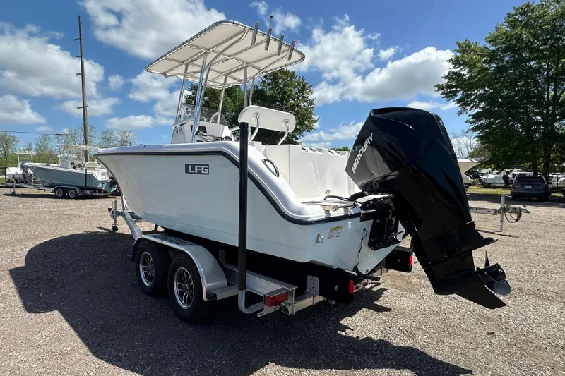 Slide: The Image of 2023 LFG 22CC boat on trailer with Mercury outboard motor, parked outdoors. - 5