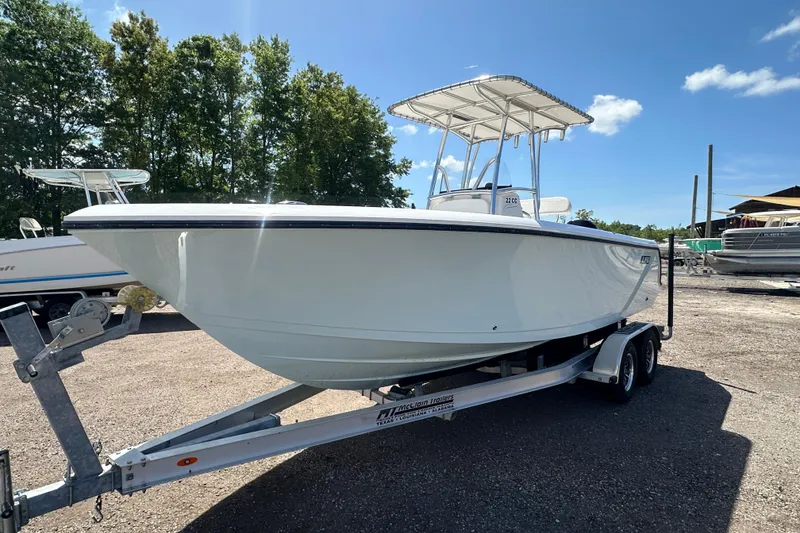 Slide: The Image of 2023 LFG 22CC boat on trailer, parked outdoors under clear blue sky. - 8