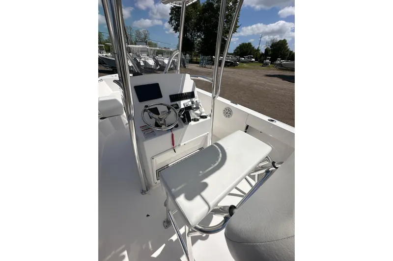Slide: The Image of 2023 LFG 22CC boat console with steering wheel and seating, under a clear blue sky. - 9