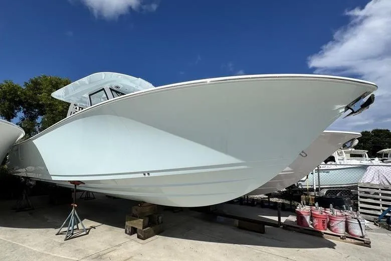 The Image of 2026 Sportsman Heritage 321 Center Console boat on display under a clear blue sky. - 0