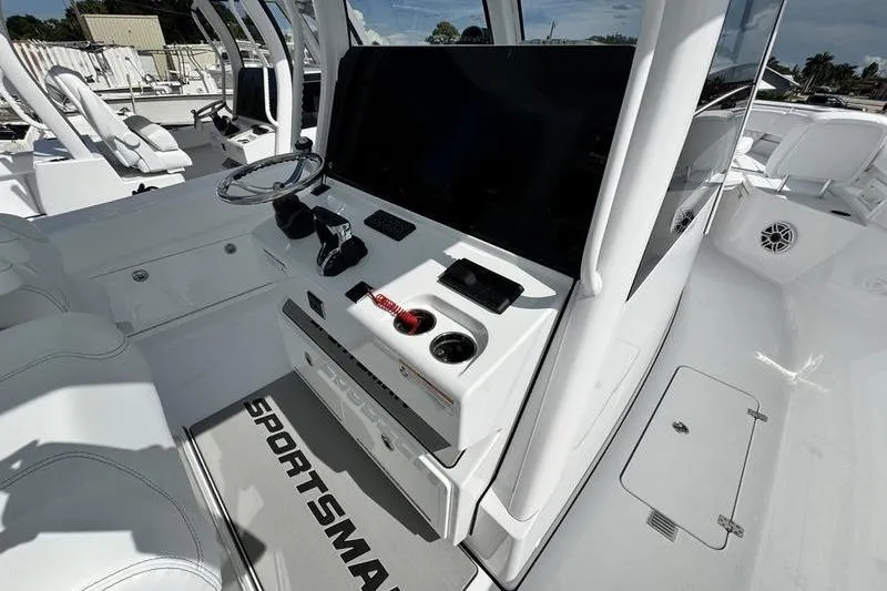Slide: The Image of 2026 Sportsman Heritage 321 Center Console boat interior with steering wheel and control panel. - 17