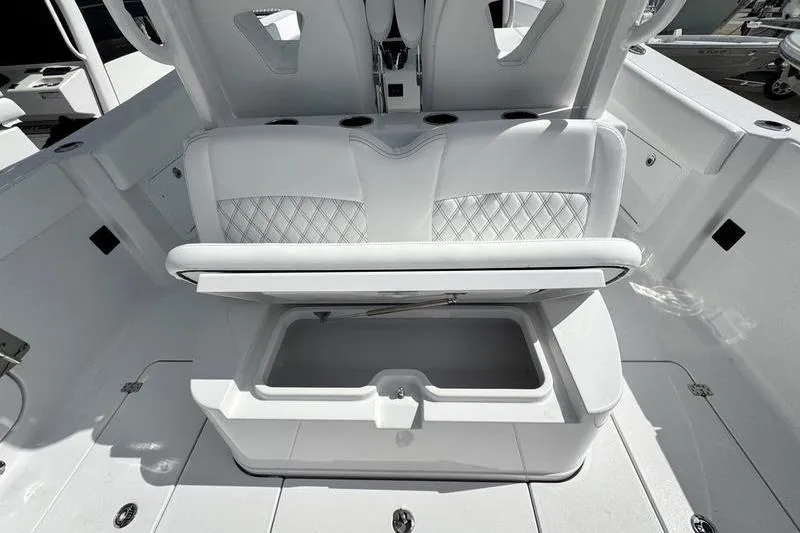 Slide: The Image of 2026 Sportsman Heritage 321 Center Console boat interior with open storage compartment. - 24