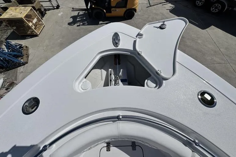 Slide: The Image of 2026 Sportsman Heritage 321 Center Console boat deck with open storage compartment. - 3