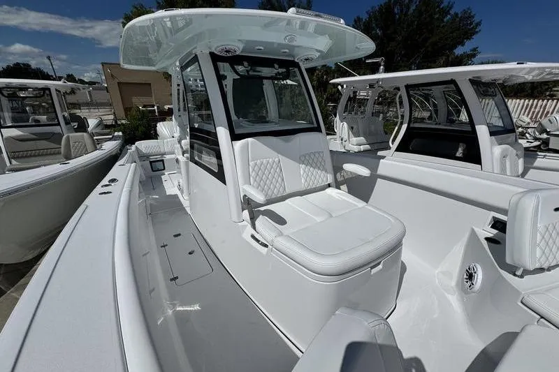 Slide: The Image of 2026 Sportsman Heritage 321 Center Console boat with sleek white design and modern features. - 9