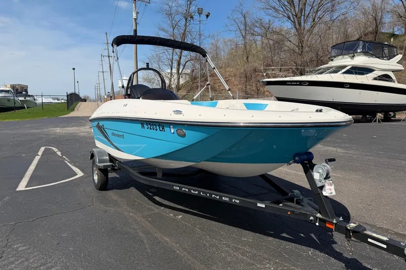 Slide: The Image of 2021 Bayliner Element E16 boat on trailer in parking lot, clear sky background. - 14