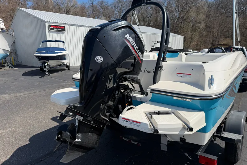 Slide: The Image of 2021 Bayliner Element E16 boat with Mercury outboard motor in a marina setting. - 15