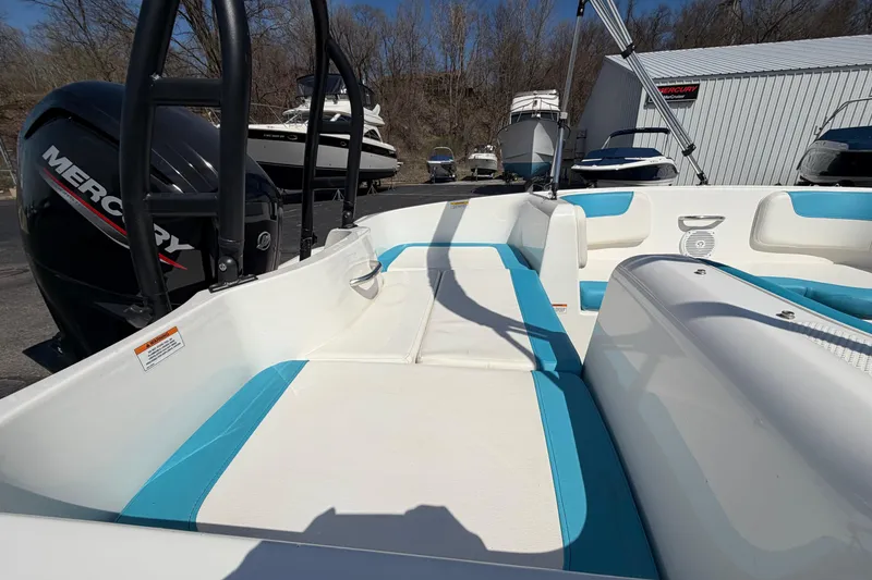 Slide: The Image of 2021 Bayliner Element E16 boat interior with blue and white seating, featuring a Mercury engine. - 22