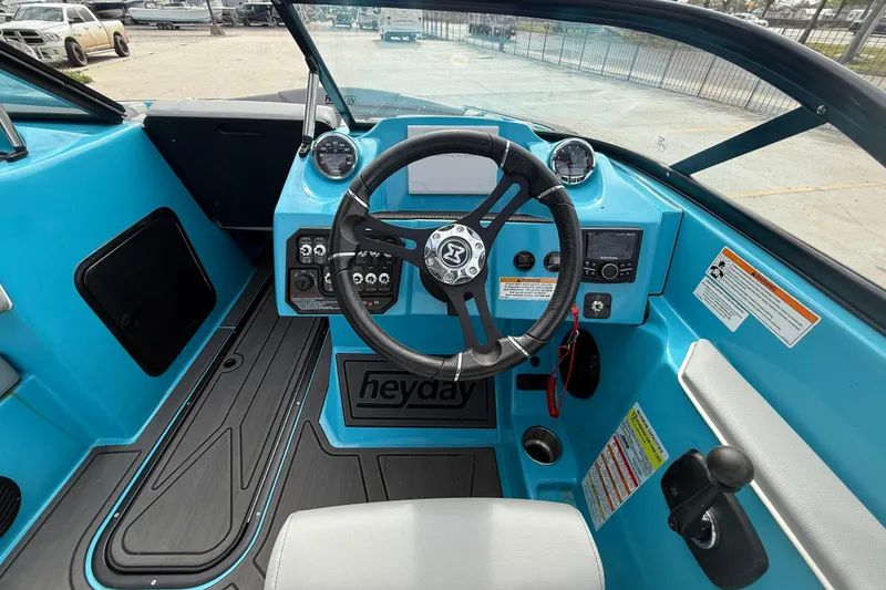 Slide: The Image of 2023 Heyday WT-2DC boat interior with blue dashboard and steering wheel. - 11