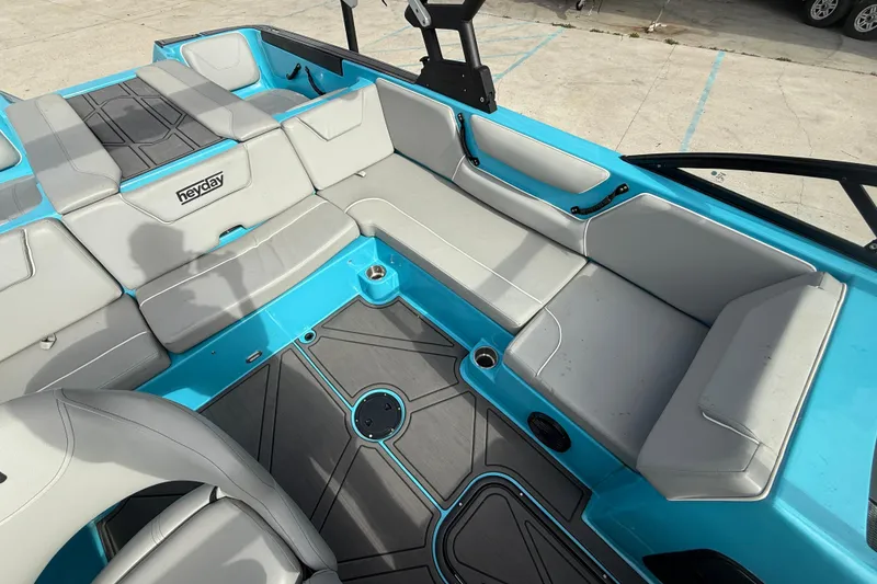 Slide: The Image of 2023 Heyday WT-2DC boat interior with gray seating and blue accents. - 14