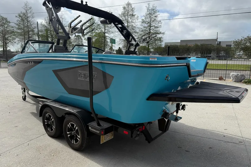 Slide: The Image of 2023 Heyday WT-2DC boat in vibrant blue on a trailer, ready for transport. - 4