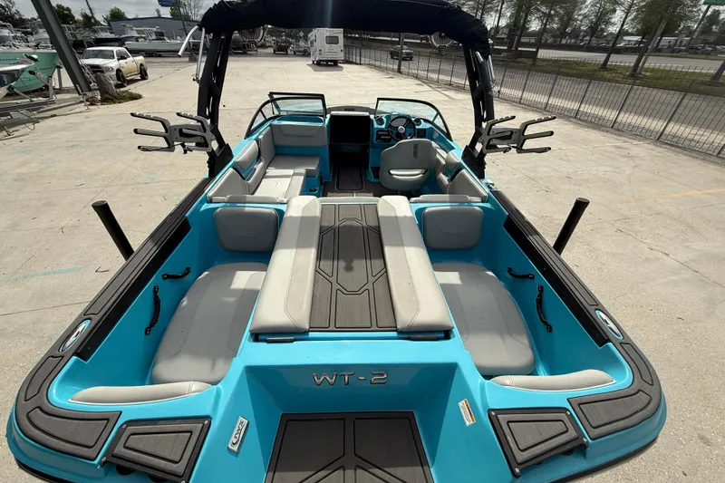 Slide: The Image of 2023 Heyday WT-2DC boat with spacious seating and modern design in a marina setting. - 7