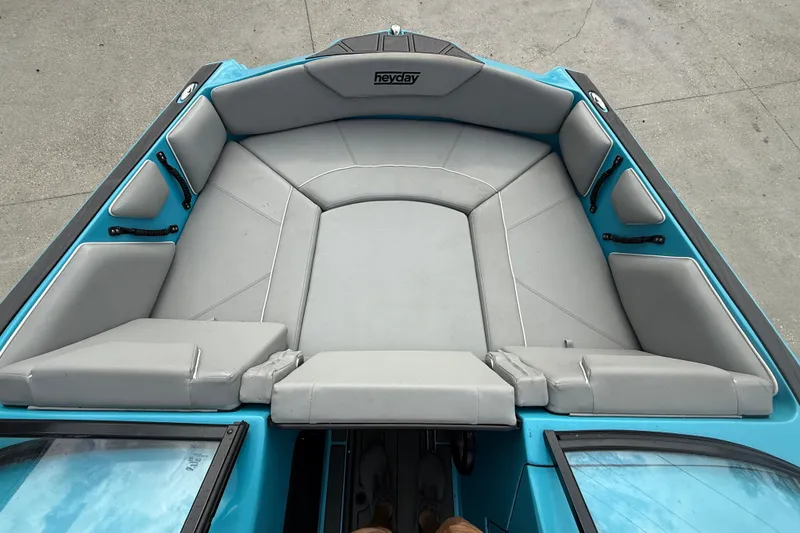 Slide: The Image of 2023 Heyday WT-2DC boat interior with gray seating and blue accents. - 8