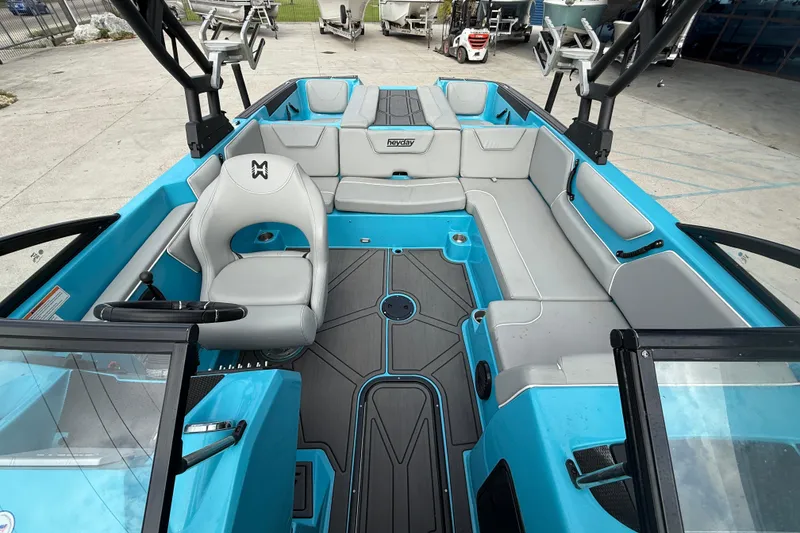 Slide: The Image of 2023 Heyday WT-2DC boat interior with blue and gray seating, spacious layout. - 9