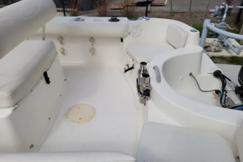 Slide: The Image of 2010 Trophy 1703 Center Console boat interior with seating and fishing rod holders. - 10