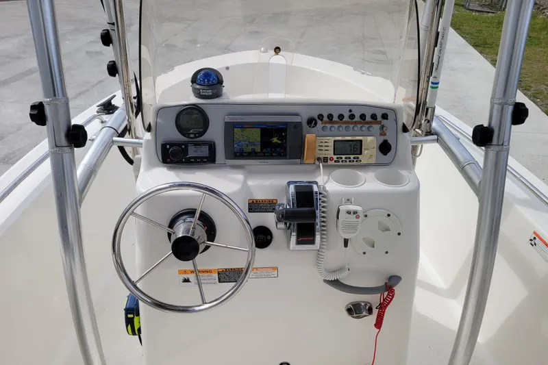 Slide: The Image of 2010 Trophy 1703 Center Console boat dashboard with steering wheel and navigation instruments. - 12