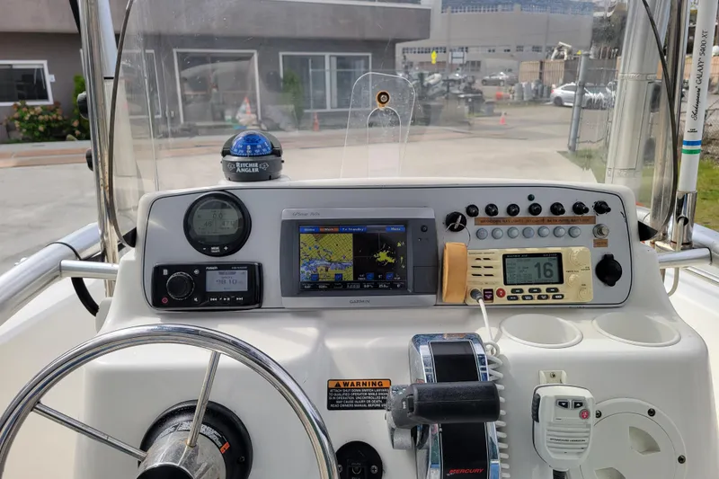 Slide: The Image of Center console of 2010 Trophy 1703 boat with navigation and communication equipment. - 13