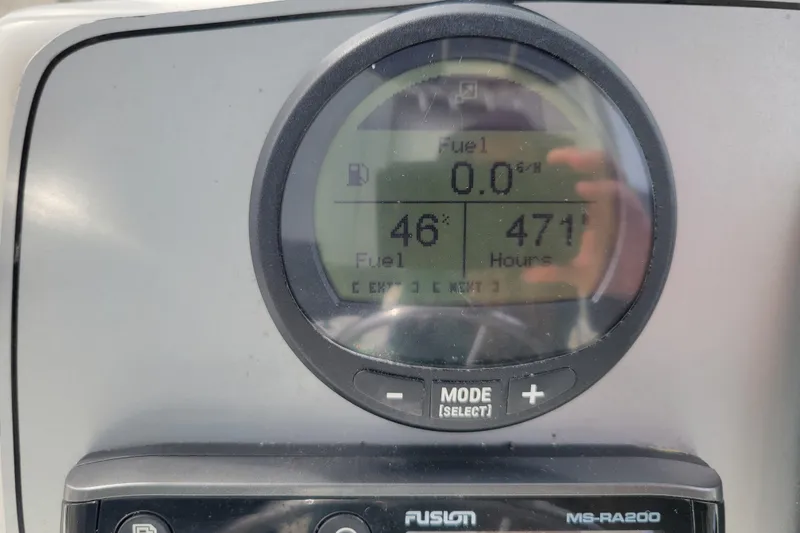 Slide: The Image of Dashboard of a 2010 Trophy 1703 Center Console boat showing fuel and hours. - 14