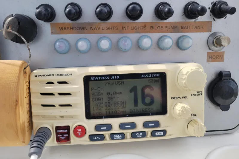 Slide: The Image of Control panel of a 2010 Trophy 1703 Center Console with radio and switches. - 17