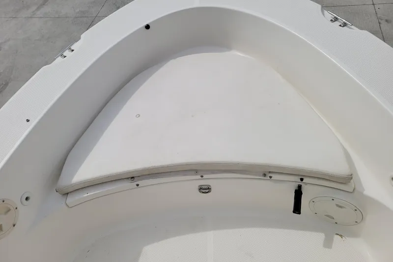 Slide: The Image of 2010 Trophy 1703 Center Console boat interior with white seating and storage compartments. - 19