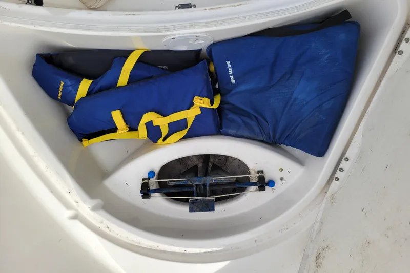 Slide: The Image of Storage compartment of 2010 Trophy 1703 Center Console with blue life jackets. - 20