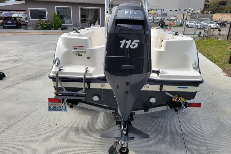 Slide: The Image of 2010 Trophy 1703 Center Console boat with 115 EFI outboard motor, parked on trailer. - 3
