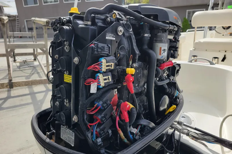 Slide: The Image of Open engine of a 2010 Trophy 1703 Center Console boat, showcasing wiring and components. - 31