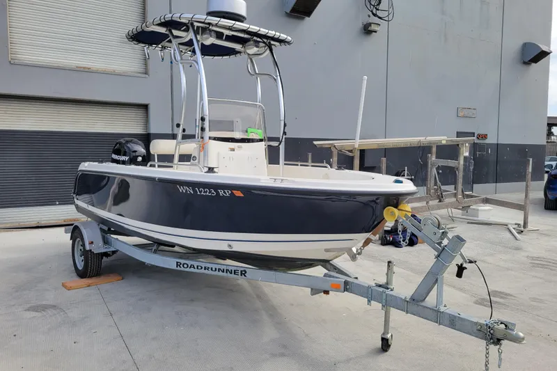 Slide: The Image of 2010 Trophy 1703 Center Console boat on trailer in industrial setting. - 6