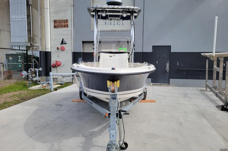 Slide: The Image of 2010 Trophy 1703 Center Console boat on trailer, parked in an industrial area. - 7
