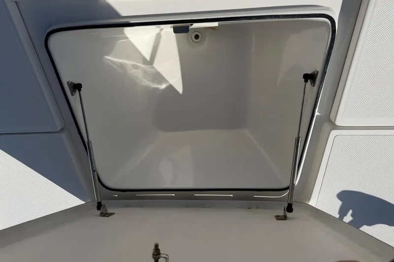 Slide: The Image of Open storage compartment on a 2017 Epic 23 Sport Console boat. - 10
