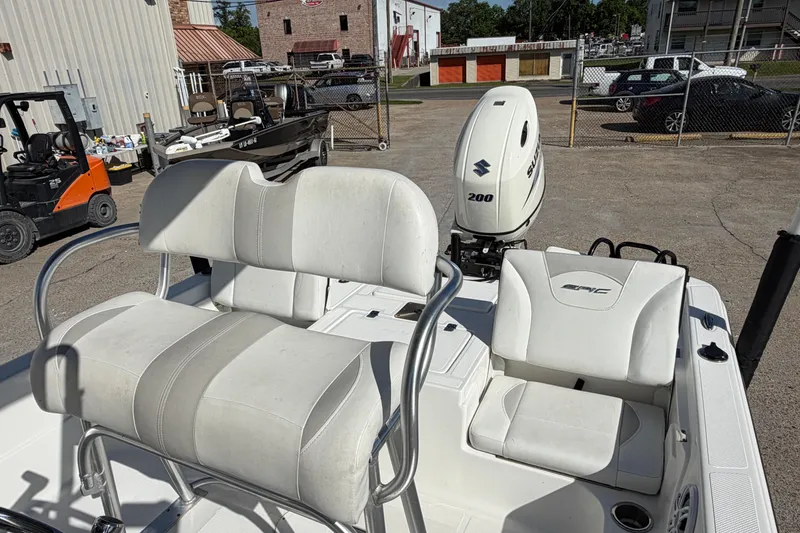 Slide: The Image of 2017 Epic 23 Sport Console boat with Suzuki 200 engine in a parking lot. - 15
