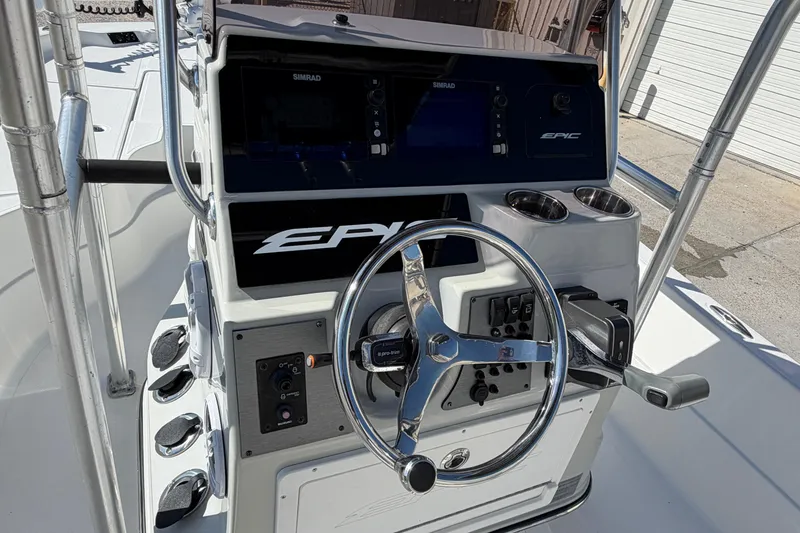 Slide: The Image of 2017 Epic 23 Sport Console boat dashboard with steering wheel and controls. - 16