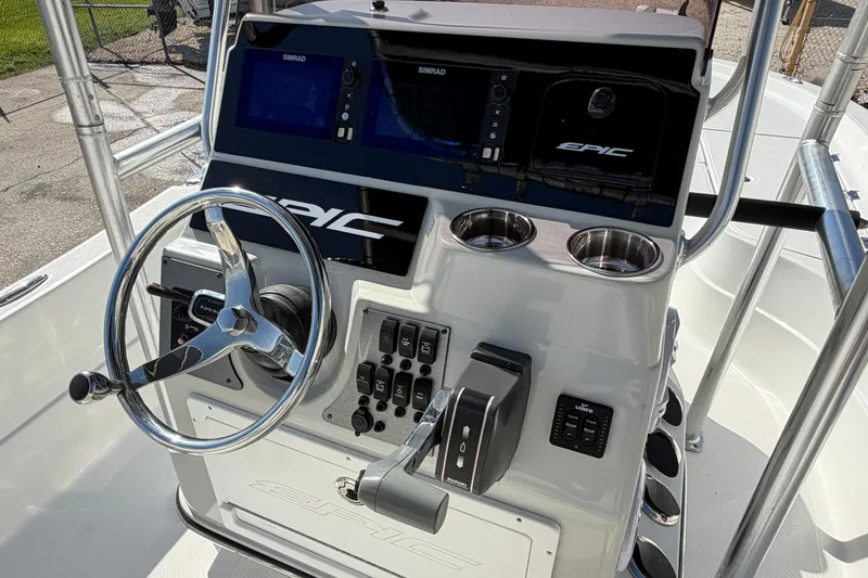 Slide: The Image of 2017 Epic 23 Sport Console boat dashboard with steering wheel and control panel. - 17