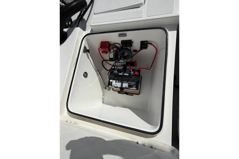 Slide: The Image of Battery compartment of 2017 Epic 23 Sport Console boat, showing wiring and connections. - 21