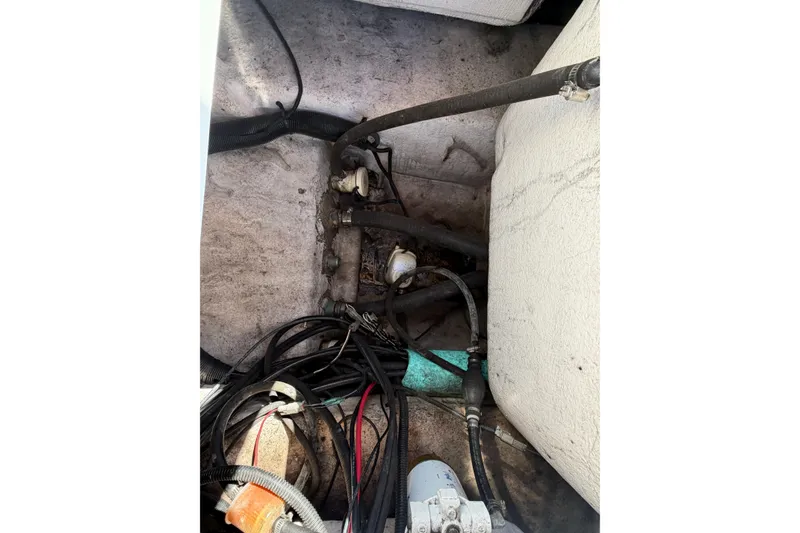 Slide: The Image of Interior view of 2017 Epic 23 Sport Console boat wiring and hoses. - 23