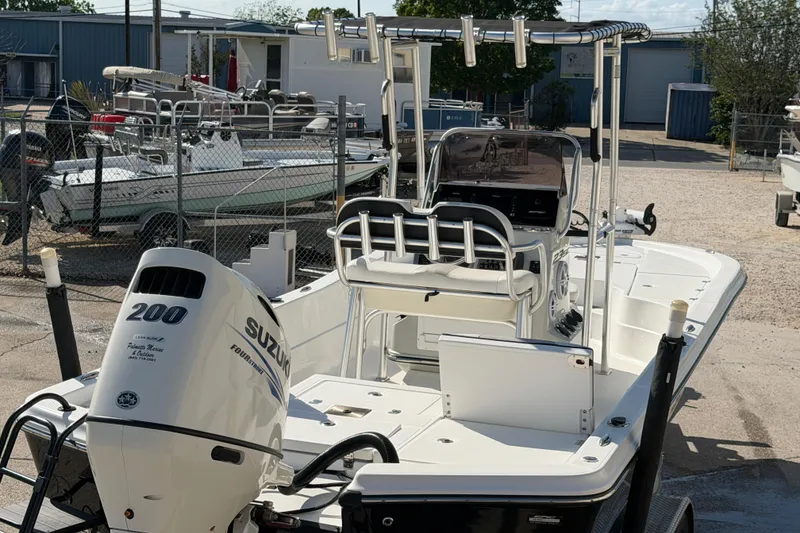 Slide: The Image of 2017 Epic 23 Sport Console boat with Suzuki 200 engine, parked in a marina. - 7