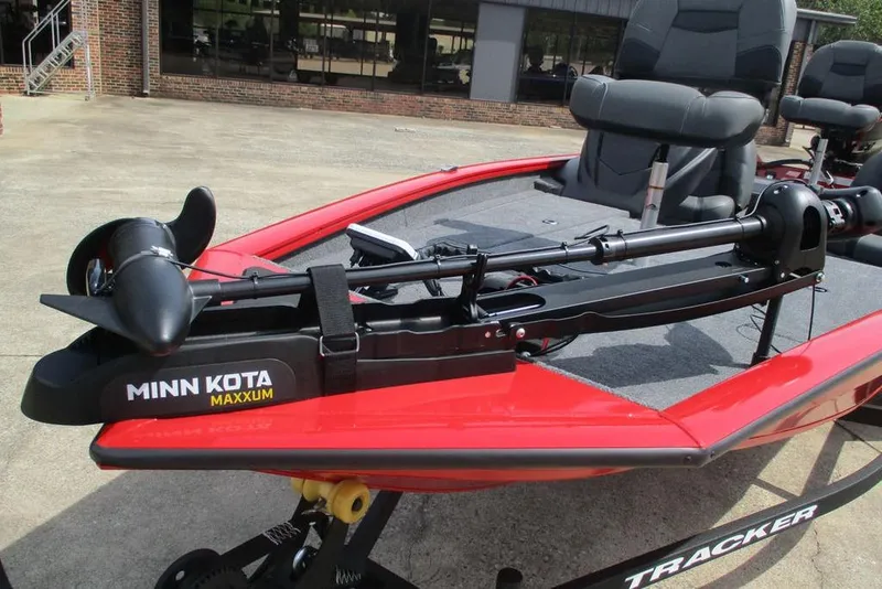 Slide: The Image of 2026 Tracker Pro Team 175 boat with Minn Kota Maxxum trolling motor, red exterior. - 10