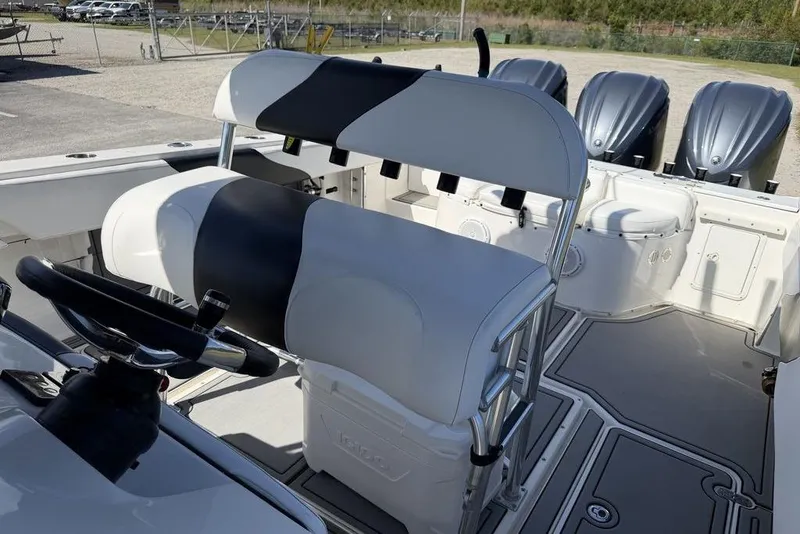 Slide: The Image of 2004 Fountain Bluewater 34 CC boat interior with steering wheel and seating. - 11