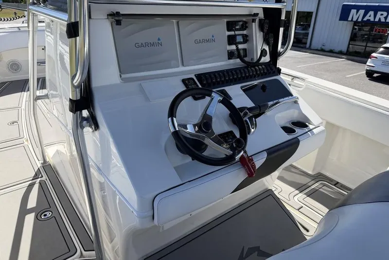 Slide: The Image of 2004 Fountain Bluewater 34 CC boat console with Garmin electronics and steering wheel. - 13