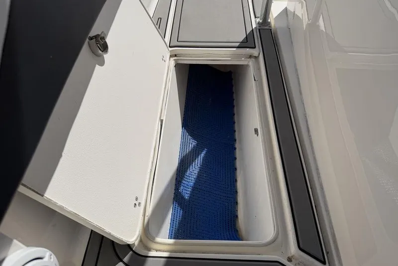 Slide: The Image of Open storage compartment on 2004 Fountain Bluewater 34 CC boat. - 14