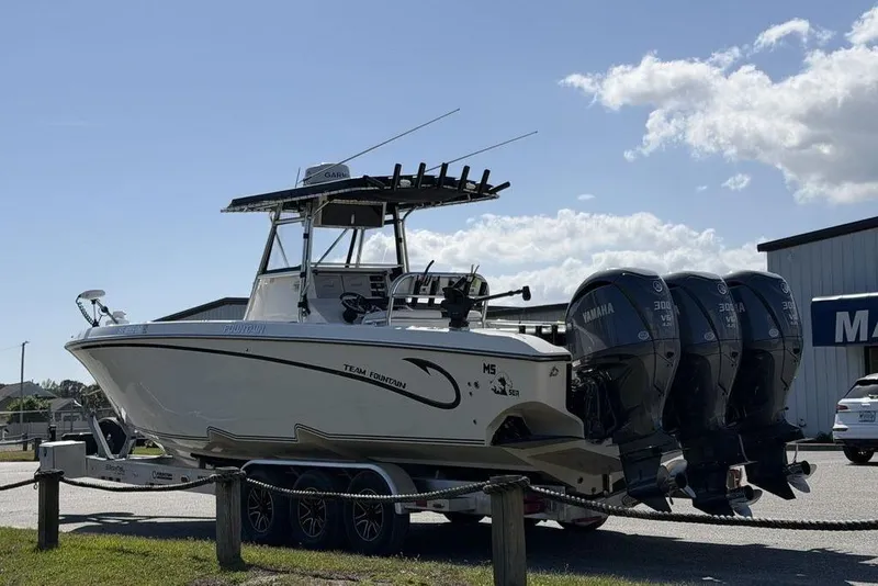 Slide: The Image of 2004 Fountain Bluewater 34 CC boat with triple Yamaha engines on a trailer. - 15