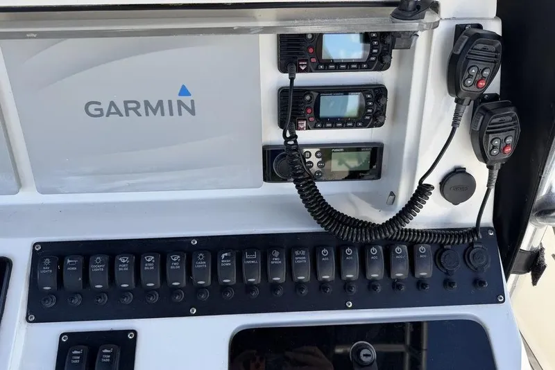 Slide: The Image of Control panel of a 2004 Fountain Bluewater 34 CC with Garmin electronics and communication devices. - 21